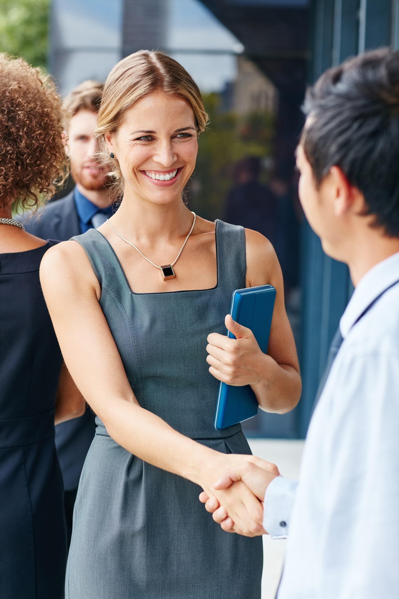 Network your way to success. Shot of a businesswoman and businessman shaking hands outdoors.