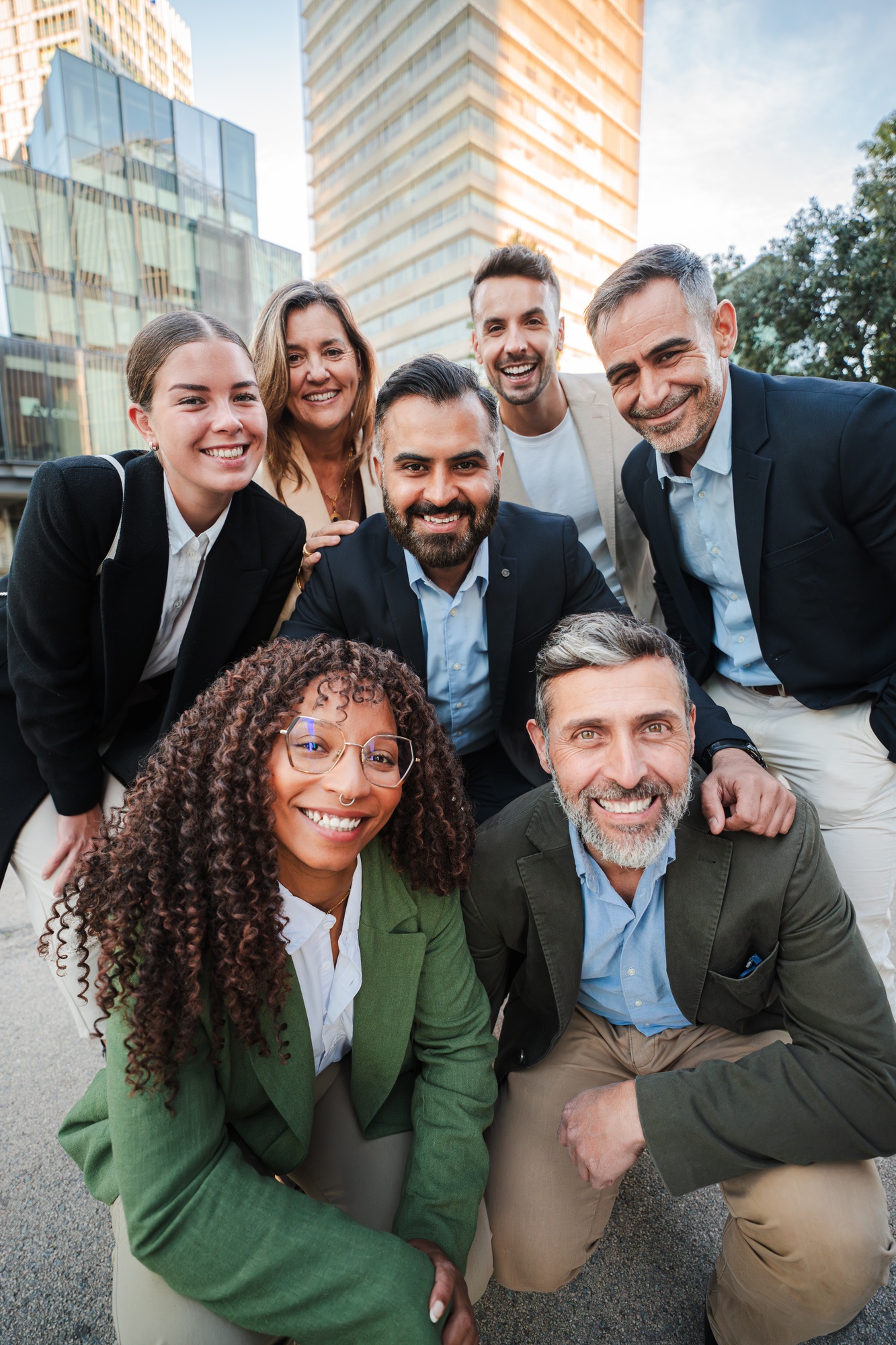 Vertical. Diverse group of business professionals smiling and looking at the camera during an